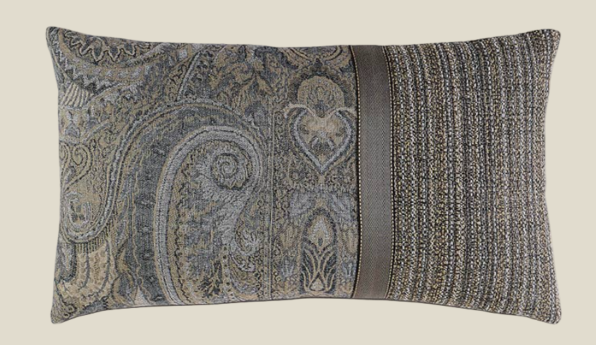 Decorative pillow with paisley pattern and ribbed texture on a beige background